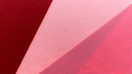 overlapping deep red light and dark pink textured paper 