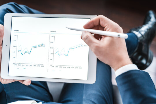 Working businessman,investor,trader.Financial report,presenatation in tablet.Diagram,gantt chart, analytics,project profit evaluation.Business meeting,negotiations.CEO,general manager.Bank investment