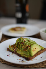 Green avocado dish with spices in a plate 