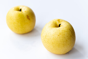 Two Korean pears isolated with a white background