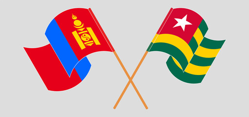 Crossed and waving flags of Mongolia and Togo