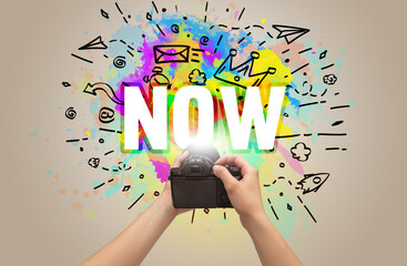 Close-up of a hand holding digital camera with abstract drawing