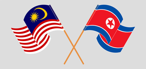 Crossed and waving flags of Malaysia and North Korea