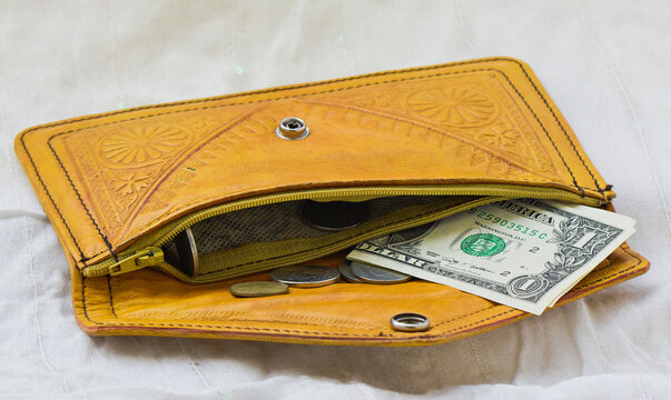 photo of a Moroccan orange leather wallet with a dollar and coins