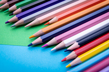Colorful pencil set on blue and green background