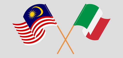 Crossed and waving flags of Malaysia and Italy