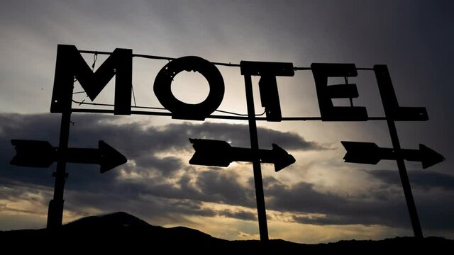Abandoned Motel Billboard, Time Lapse at Sunrise with Fast Clouds and Dark Silhouette of Old Sign