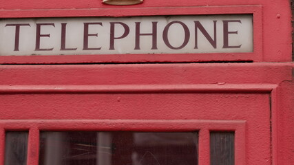 Fototapeta premium Old red telephone box close-up
