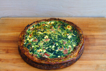 A potato crust quiche with spinach, bacon and goat cheese