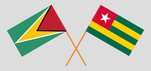 Crossed flags of Guyana and Togo. Official colors. Correct proportion