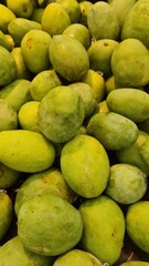 green mangoes for sale in market