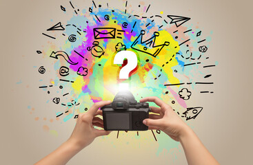 Close-up of a hand holding digital camera with abstract drawing concept