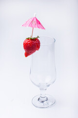 empty cocktail glass with red strawberries. On a white background