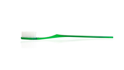 green plastic toothbrush on white background