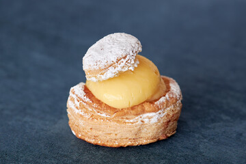 Close-up of appetizing puff pastry cake filled with custard