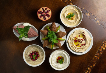 Traditional Middle Eastern food. Lebanese food. Arabian Baba Ghanoush with Pomegranate seeds, Labneh yorgut, Hummus, raw kibbeh. Top view