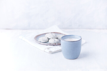Cappuccino and white chocolate cookies on bright wooden background. Copy space.	