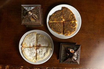 Traditional Middle Eastern food. Lebanese. Arabian cuisine. Manakish, lamps. Top view