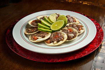 Traditional Middle Eastern food. Lebanese Sfiha meat. Arabian sfeeha plate. Esfiha with lemons on a wood base