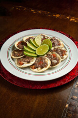 Traditional Middle Eastern food. Lebanese Sfiha meat. Arabian sfeeha plate. Esfiha with lemons on a wood base