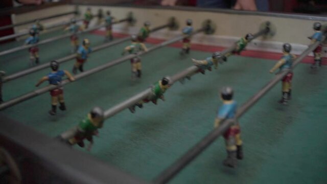 Close-up of foosball table match. Retro Football board game. Slow Motion