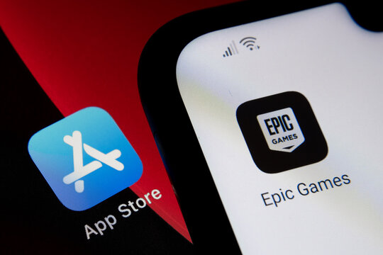 App Store vs Epic Games. Concept. App Store icon seen on ipad and Epic Games Fortnight icon seen on android phone. Selective focus. Stafford, UK, May 2, 2021.
