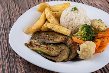 Dish Made - Oven-baked eggplant with spices, rice, rustic potatoes, carrots, cauliflower and brocolis