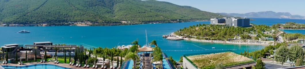 Fototapeta na wymiar Stunning Turkey landmark of Island Bodrum. Tropic resort in lagoon with green exotic plants and trees. Greenery tropical nature at summer sunny day aerial view. Lux resort vacation conception