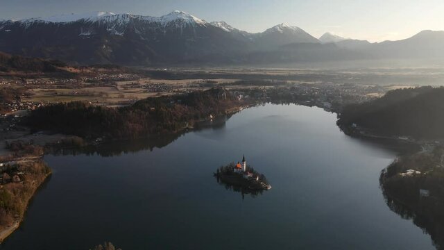 Bled lake with picturesque church on Bled Island, Slovenia. Aerial establishing shot
