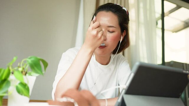 slow motion scene on  young pretty asian woman try to eating sliced of chocolate cake at cafe bar in break-time and use tablet to surf the internet or social media network  for relax emotion concept	