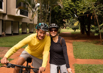 Mature couple outdoors in an urban area on their bikes