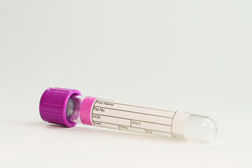 vacuum tube for collection and blood samples on white background..Transparent with purple lid....