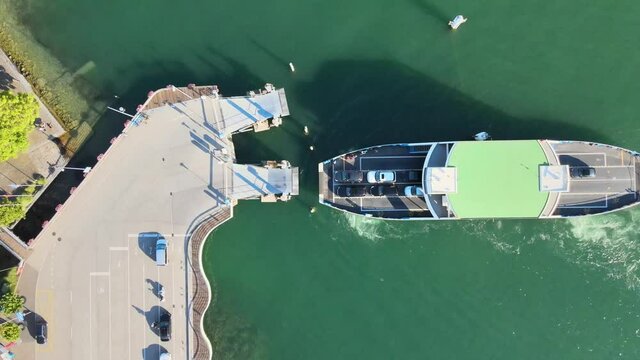 Top down aerial drone shot of car ferry arriving at Meilen on Lake Z&uuml;rich in Switzerland