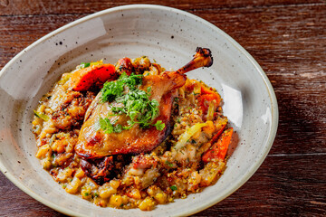 duck confit with lentils. restaurant meal