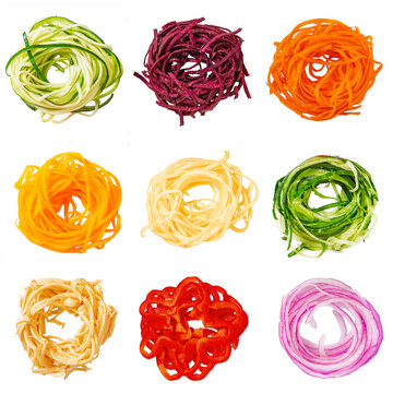 set of various vegetable noodles. spiralized zucchini, beets, pumpkin, squash, sweet potatoes, cucumber, vegetable banana, red pepper, red onion.  isolated on white background.
