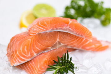 Raw salmon filet with herbs and spices on white background, Fresh salmon fish on ice