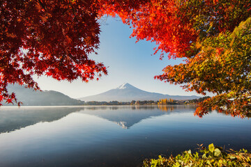 Naklejka na ściany i meble Fuji Mountain Reflection and Red Maple Leaves with Morning Mist at Kawaguchiko Lake, Japan