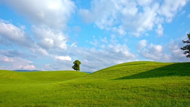 Time lapse, clouds flowing over meadow
in Hirzel, Switzerland, forming shadows 