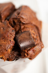 Freshly baked extra large chocolate muffin on a white background.
