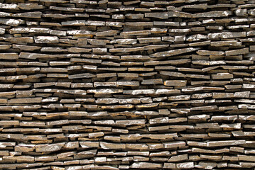 Slabs or flagstones stacked as gray background wall