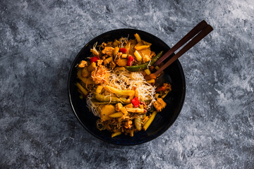 vegan stir fry with mixed asian vegetables and vermicelli noodles, healthy plant-based food