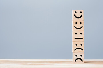 smile face symbol on yellow wooden cube blocks. Emotion, Service rating, ranking, customer review, satisfaction and feedback concept