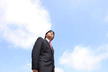 Young Japanese businessman walking in the american business district	

