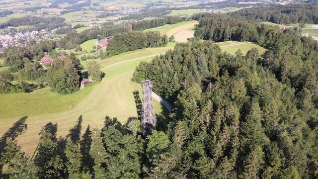 Aerial high drone shot flying around the Pfannenstiel observation tower in the canton of Z&uuml;rich, Switzerland