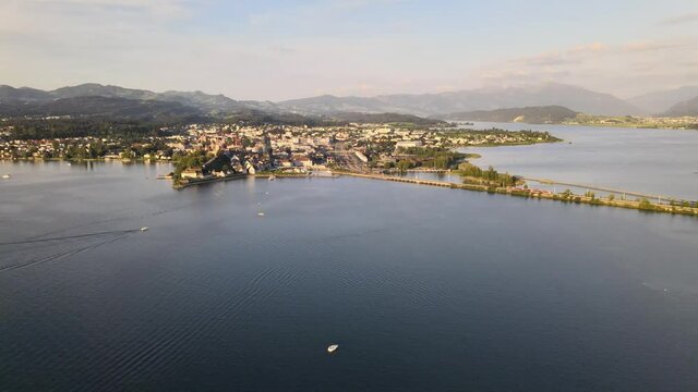 Aerial drone dolly shot flying sideways showing Rapperswil on a summer evening