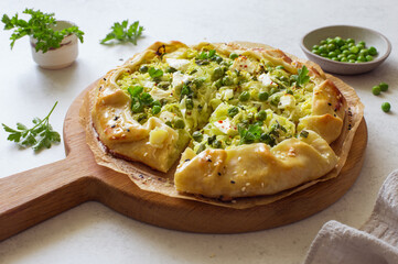 Cabbage, green peas and feta cheese opan face pie(galette) close up