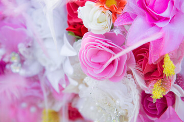 Floral background. Lot of artificial flowers in colorful composition,closeup flowers background