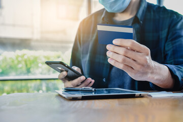 Man shopping online by credit card ,Close up hand holding mobile phone shopping online with credit, Man stay at home protect coronavirus covid19