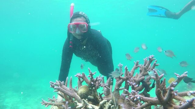 Happy woman diving underwater at Karimun Jawa