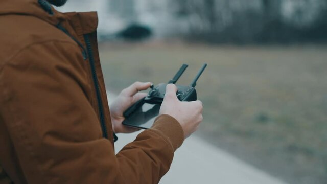 Young man flying a drone outside